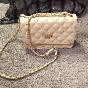 White cross body hand bag with red interior.